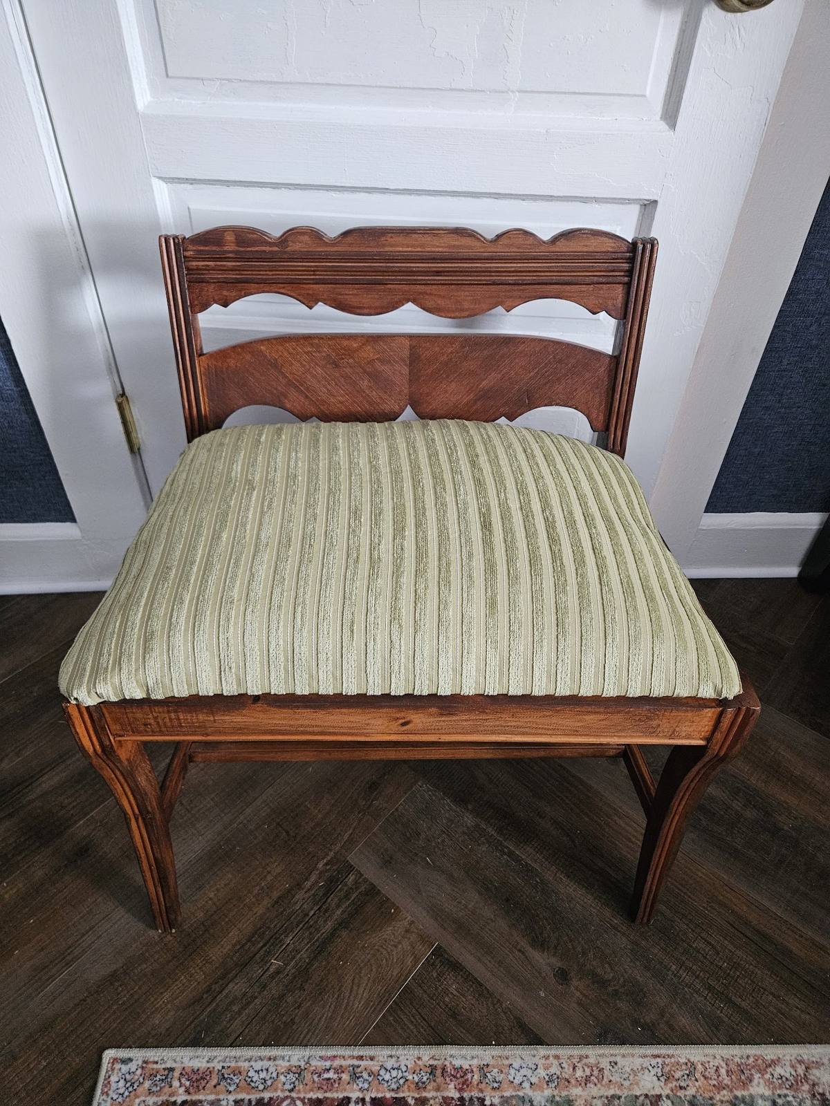 The same vanity bench after the wood was refreshed and the seat reupholstered