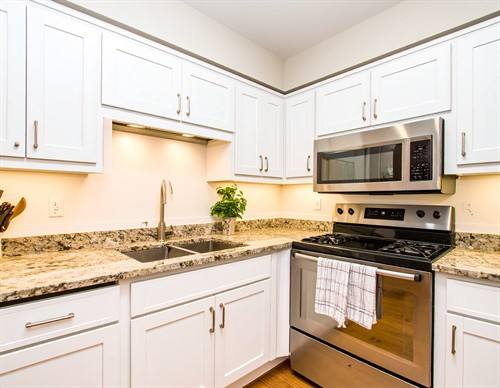 Completed white kitchen featuring Qwikkit cabinet products