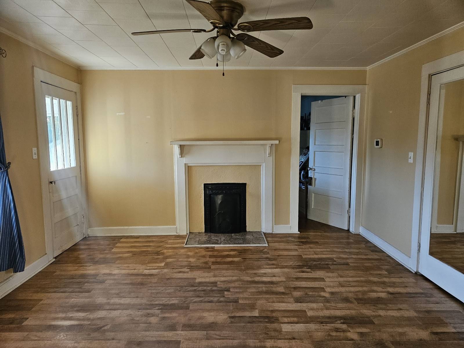 Room with the lighter old wood-look floor before removal