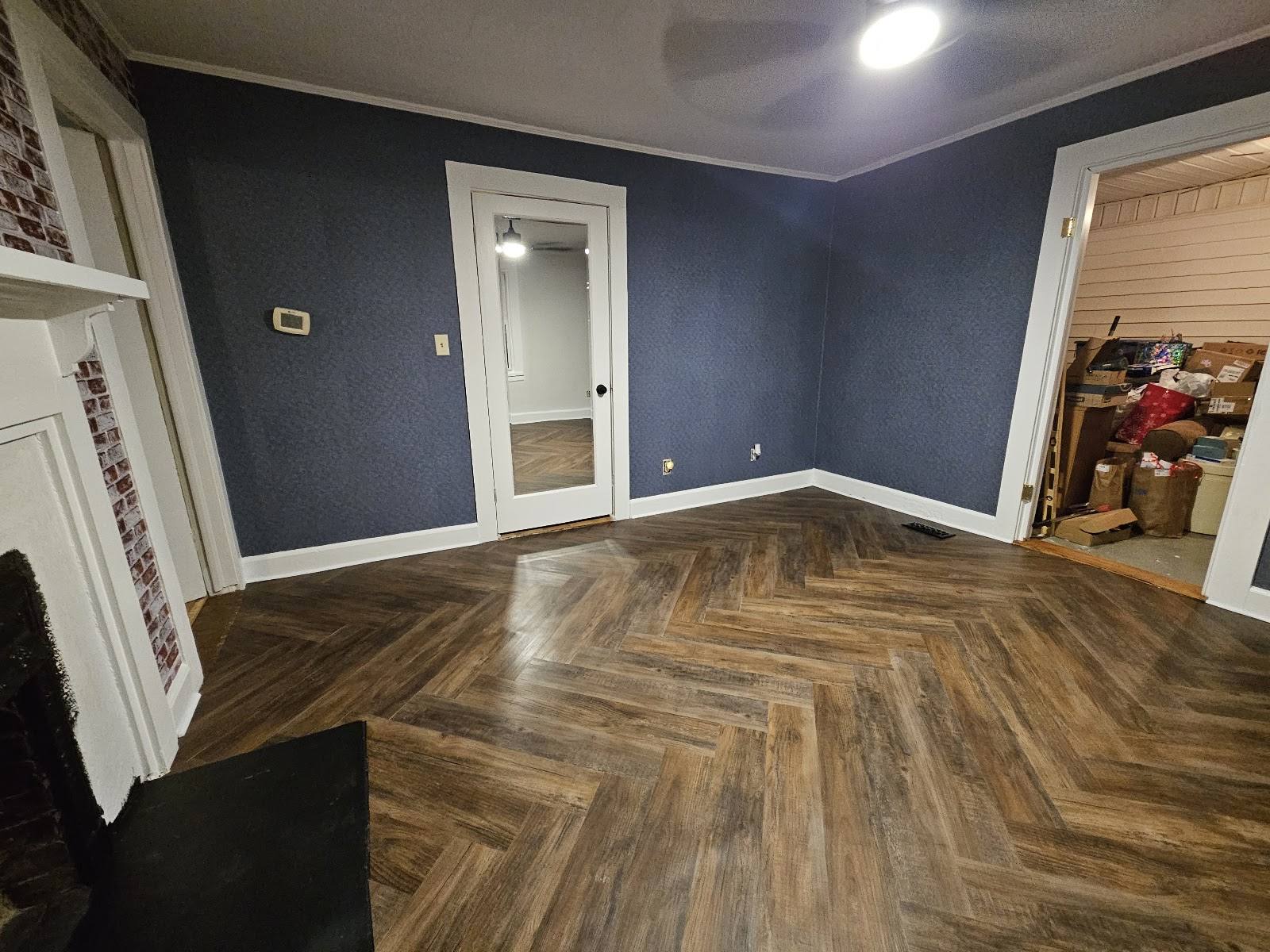 Completed remodeled room with dark walnut herringbone LVP